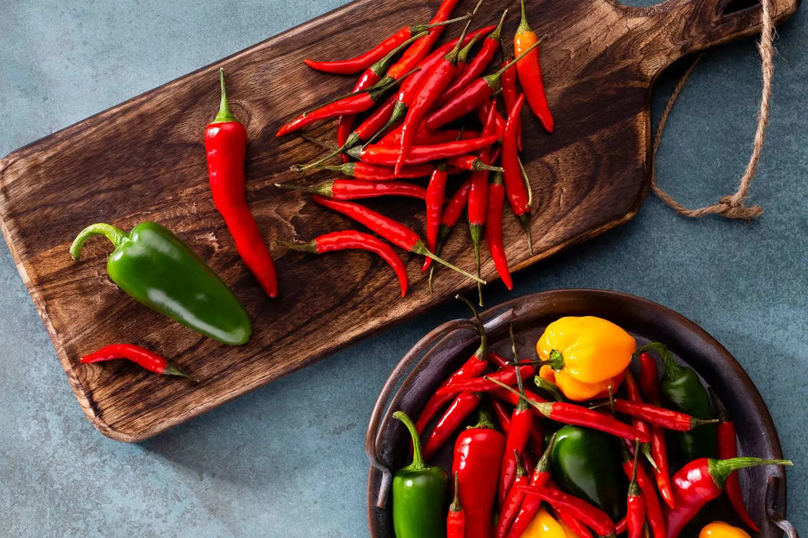 Red and green chiles on a wooden board