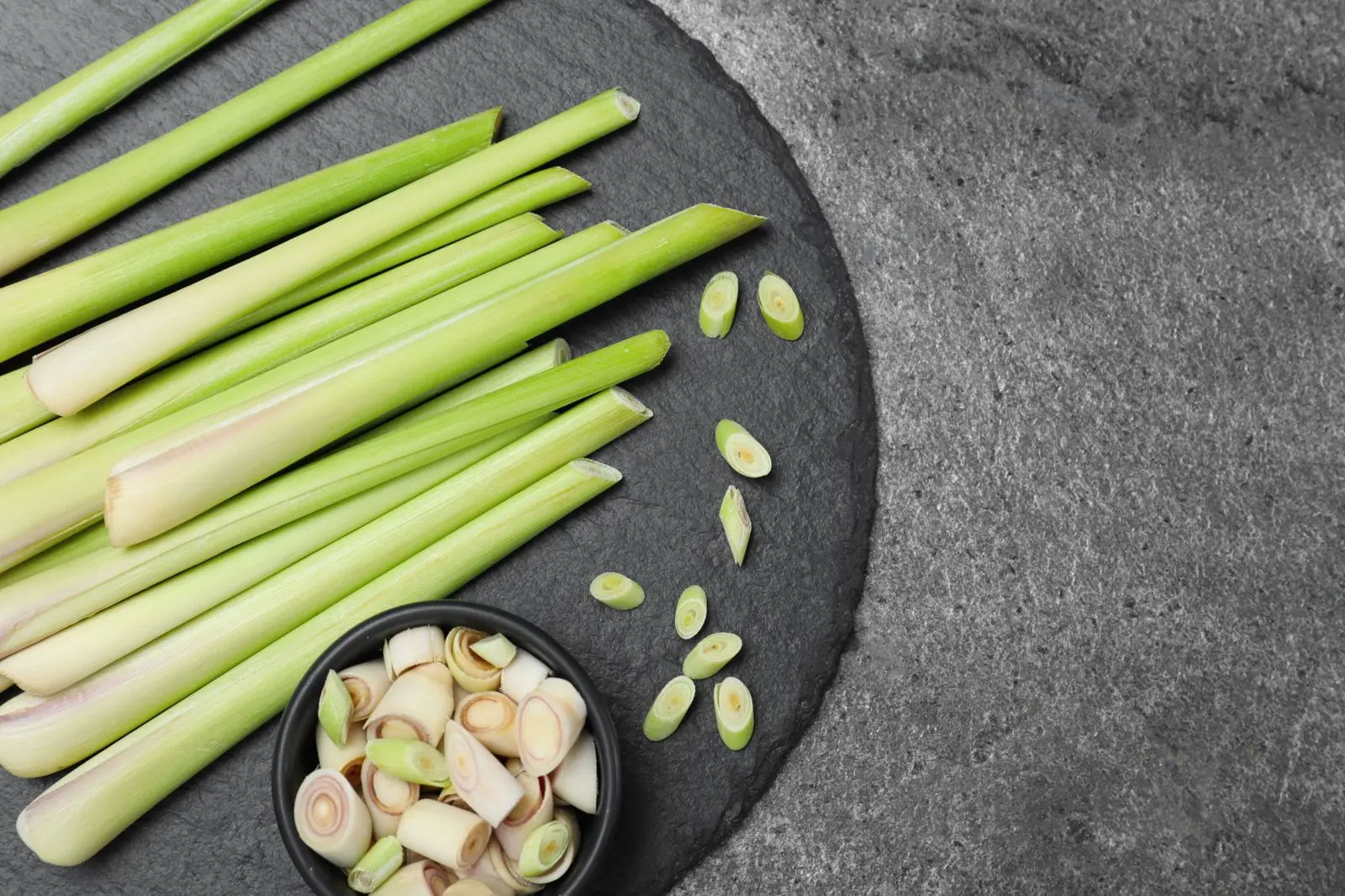 Fresh lemongrass stalks on slate